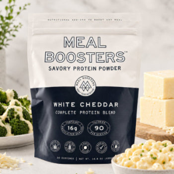 Meal Boosters savory protein powder package with food items in the background